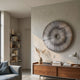 Oculis Warm Neutral Circular Handmade 3D Paper Wall Art by Giant Sculptures displayed above a walnut sideboard in a neutral living room with bookshelves.