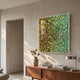 Chromatica Square Vibrant Green Rolled Paper 3D Wall Art by Giant Sculptures displayed above a walnut sideboard with vase, books, and lamp in a modern living room.