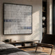 Tracery VI Blue & White Textured Paper Wall Art by Giant Sculptures displayed above a low wooden console in a sunlit bedroom with leather chair and bookshelf.