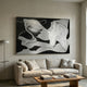 Calmant Black & Silver Abstract Hand-Painted Wall Art by Giant Sculptures hung above a linen sofa in a neutral living room with a floor lamp and wood coffee table.