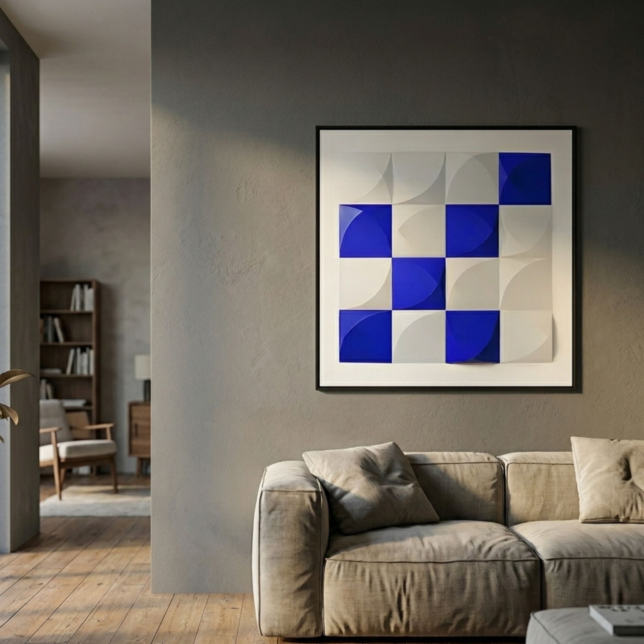 Geometrica Bold Blue & White Grid 3D Wood Relief Wall Art displayed above a beige linen sofa on a grey wall in a modern living room.