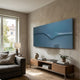 Velar Horizontal Blue Wood Carving 3D Wall Art by Giant Sculptures mounted above a wooden console in a modern living room with a grey sofa and window.