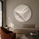 Selene III White Sandstone Textured 3D Wood Relief Wall Art mounted above a beige curved sofa with a rust armchair and dark round coffee table.