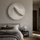 Selene II White Sandstone Textured 3D Wood Relief Wall Art mounted above an upholstered bed with linen bedding, dome lamp, and dark nightstand.