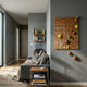 Giant Sculptures Orbison Brown 3D Wood Relief Wall Art with carved topographical surface and floating brown and yellow spheres, mounted in a grey-walled living room beside a sofa.