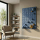 Orbison Blue 3D Wood Relief Wall Art with tonal blue and gold metal spheres mounted on a carved organic surface, displayed in a living room beside a bookshelf and armchair.