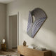 Orison Monochrome Fusion UV 3D Wood Wall Art by Giant Sculptures with curved navy and black linework on a fan-shaped panel, displayed above an oak sideboard in a hallway.