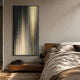 Celeste Gradient Flow LED Wall Art by Giant Sculptures, vertical cream, beige, grey and black light bands in a black frame, mounted above a wooden bedside bench in a modern bedroom.