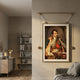 Aristo Napoleon Portrait Painting by Giant Sculptures in a gold frame with leather strap suspension, displayed on a neutral wall above a grey sofa near a bookshelf.