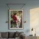Giant Sculptures Aristo Romantic Swing gold frame wall art depicting two children on a garden swing, displayed above a grey sofa on a soft blue wall.