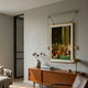 Aristo Coronation Painting Gold Frame Hanging Wall Art by Giant Sculptures, suspended from a brass rail above a teak sideboard in a neutral living room.