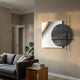 Tesselle White Metal Fold & Grey Textured Geometric Wall Art by Giant Sculptures displayed on a beige living room wall above a grey sofa and monstera plant.
