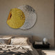 Metaluxe I Gold & Silver Dual Disc Textured 3D Wall Art mounted above an upholstered bed with linen bedding and a dark bedside shelf.