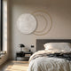 Eclipse Luxe Bianco White Marble Circular Ring Wall Art by Giant Sculptures mounted above a dark nightstand in a neutral bedroom with linen bedding.