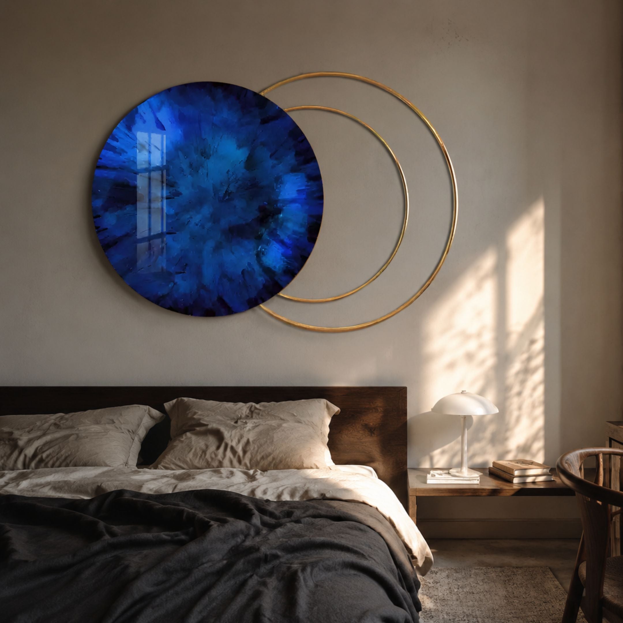 Eclipse Luxe Sapphire Blue Circular Ring Wall Art by Giant Sculptures displayed above a wooden bed with grey linens, beside a nightstand with a lamp.