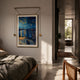 Reverra Starry Night Over The Rhone Hanging Frame Wall Art suspended from gold cords above a wooden bed in a sunlit modern bedroom.