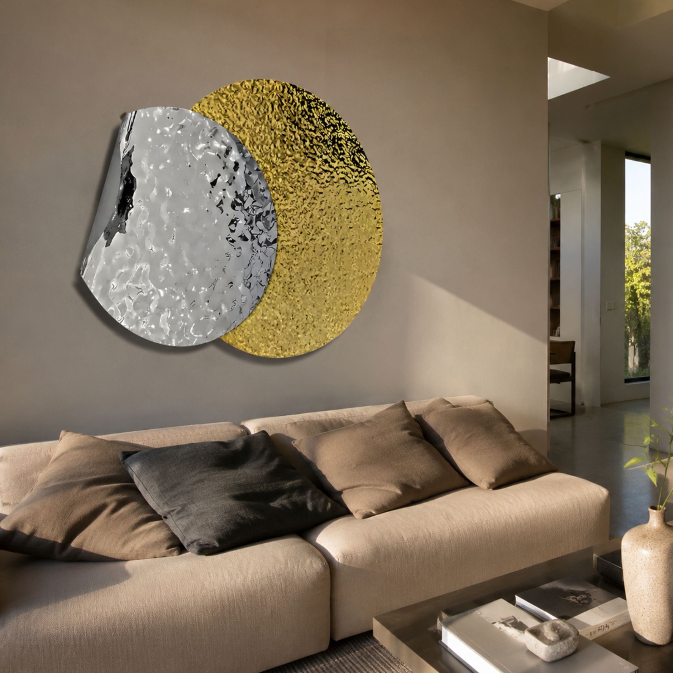 Metaluxe II Gold & Silver Dual Disc Textured 3D Wall Art mounted above a beige sofa in a neutral living room, with overlapping hammered silver and gold discs.