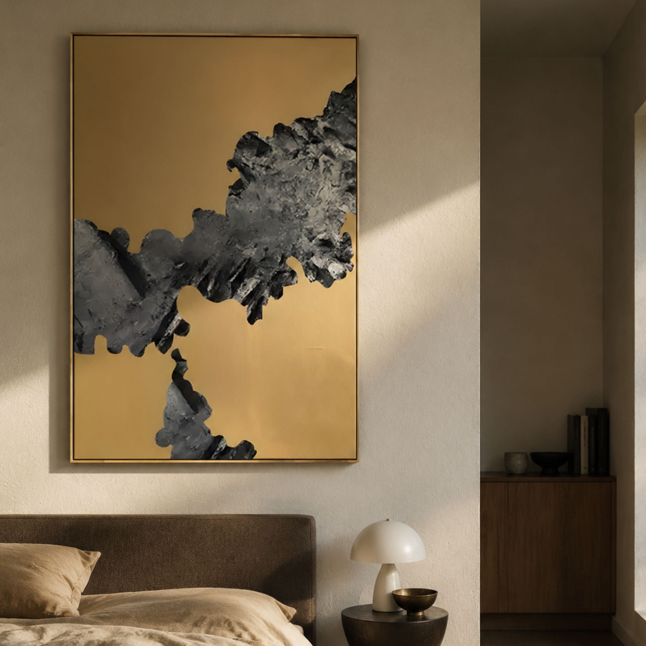 Terranica Metallic Stream Textured Abstract Metal Wall Art by Giant Sculptures displayed above a bed, featuring a jagged silver-black form across a gold field.