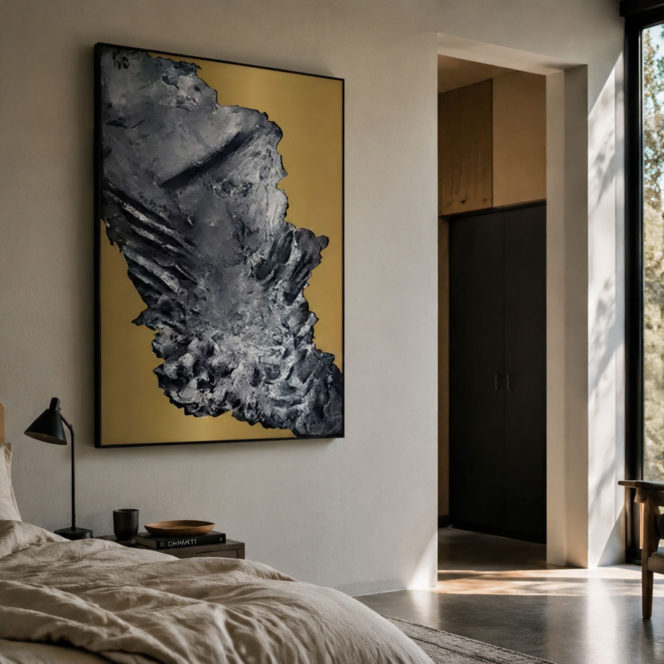 Terranica Metallic Crust Textured Abstract Metal Wall Art by Giant Sculptures, grey crust relief on gold, hung above a linen bed in a sunlit modern bedroom.