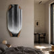 Celestial Flow Waterfall Edge Folded Abstract Metal Wall Art in black, white and gold mounted on a bedroom wall beside a desk nook.