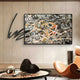 Graffio Urban Chaos Orange Network Abstract Wall Art by Giant Sculptures displayed above a console with black iron scribble extending past the frame in a modern lounge.