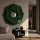 Sculptura Mirror Forest Green Floral Round Metal Wall Art with layered petals around a central mirror, displayed above a black console in a living room.