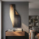 Celestial Midnight Gradient Curved Angled Abstract Metal Wall Art by Giant Sculptures, mounted on a grey wall above a walnut console in a modern living room.