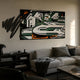 Graffio Graphic Edge Fragmented Abstract Wall Art by Giant Sculptures in black, white, green, and orange, mounted above a grey sofa in a modern living room.