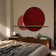 Luna Forma Scarlet Red Round Brass Accent Wall Art by Giant Sculptures displayed above a walnut console in a bedroom, with overlapping red discs and brass rod.