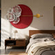 Giant Sculptures Blossom Halo Red Round Floral Decorative Wall Art mounted above a walnut nightstand and bed, with white floral relief and a gold crossing rod.