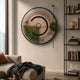 Circulo Modern Kinetic Metal Wall Art by Giant Sculptures mounted above a beige sofa, featuring concentric rings, green acrylic accents, and silver spheres.