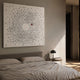 Aviara Unity Circle Butterfly Sculpture Metal 3D Wall Art by Giant Sculptures mounted above a grey upholstered bed in a softly lit modern bedroom.