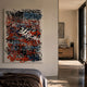 Scriptura I Multicolour Graffiti Expression Metal Wall Art with layered black, red, blue, and white scribbles displayed on a bedroom wall beside a wooden cabinet.