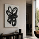 Zephyr Black Cascade Abstract Metal Wall Art by Giant Sculptures displayed above a dark wood console with books in a modern living room beside a window.