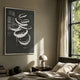 Zephyr Monochrome Swirl Abstract Wall Art by Giant Sculptures, framed white brushstroke swirls on charcoal, displayed above a bedside table in a sunlit bedroom.