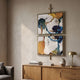 Vortice Watercolour Abstract Dual Panel Wall Art by Giant Sculptures, with blue, green, brown and white watercolour tones in gold frames above a wooden sideboard.