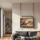 Celestique Vintage Pavilion Bliss Framed Long Hanging LED Wall Art by Giant Sculptures, suspended from ceiling rods above a grey sofa in a modern living room.