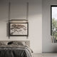 Celestique Ancient Bonsai Framed Long Hanging LED Wall Art by Giant Sculptures, mounted above a grey linen bed with overhead LED bar illuminating the ink artwork.