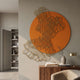 Cellura Orange Geometric Layered Gold Wired Metal Wall Art by Giant Sculptures displayed above a walnut console with vase, lamp, and books in a modern hallway.