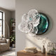 Aurum Flora White Petals Jade Metal Wall Art by Giant Sculptures displayed on a cream living room wall above a wood console with books and a vase.