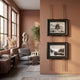 Imperia Temple and Misty Landscape Dual Frame Metal Wall Art by Giant Sculptures displayed on a terracotta wall beside a sitting area with grey armchair and sculpture.