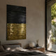 Ripple Dual-Tone Black & Gold Textured 3D Wall Art mounted above a wooden nightstand in a sunlit bedroom with plaster walls and a garden view.
