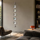 Papilio Butterfly Vertical Clear Modern 3D Wall Art by Giant Sculptures, five stacked acrylic frames on an iron rod, displayed in a sunlit living room.