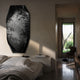 Echo Waterscape Abstract Panel Metal Etched 3D Wall Art mounted on a plaster bedroom wall, monochrome forest and reflection design above a linen bed and hallway view.