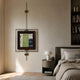 Ethereal Frames Abstract Green Vintage Suspended Wall Art by Giant Sculptures, displayed on a warm neutral bedroom wall beside a round nightstand and upholstered bed.