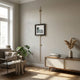 Ecliptica Mountain Landscape Gold Frame Wall Art by Giant Sculptures suspended from a brass vertical picture rail in a Scandinavian living room with monstera plant and oak sideboard.