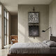 Vistarte Monochrome Abstract Dual Panel Metal Wall Art by Giant Sculptures, mounted vertically above a linen-dressed bed in a minimalist bedroom with plaster walls.