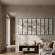 Silvienne Multi-Panel Silk Wall Art by Giant Sculptures, eight-panel mountain landscape with gold foil highlights mounted above a wooden console in a neutral living room.