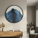 Auric I Blue Wave Abstract Copper Wire Enamel Round Wall Art by Giant Sculptures displayed above a wooden console with books and pampas grass in a modern living room.