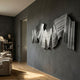 Rollscape Grey Flow Enamel Decorative Wall Art by Giant Sculptures, layered wavy folds mounted on a dark grey wall in a modern living room with bookshelf.